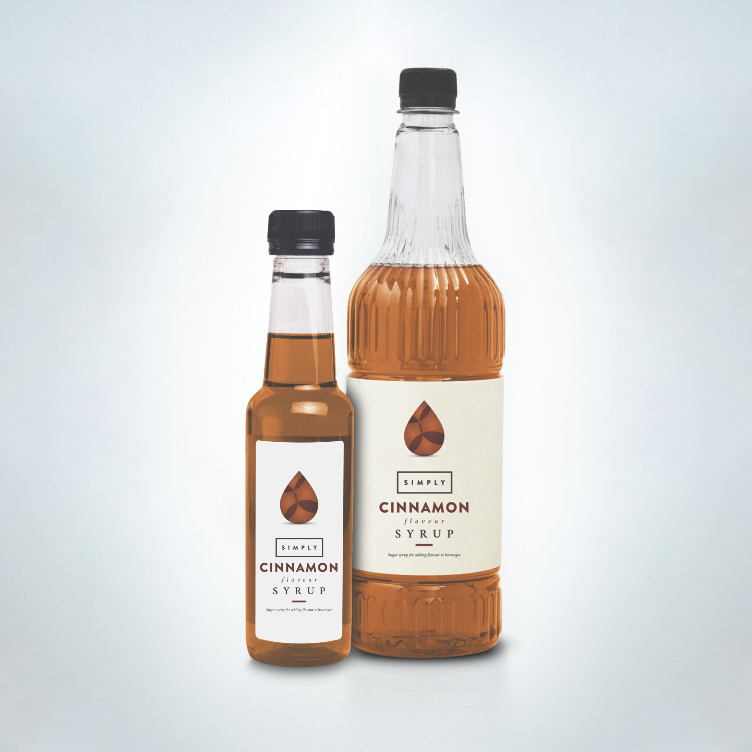 Simply Cinnamon Syrup duo in clear bottles. A warm and aromatic syrup perfect for spicing up lattes, hot chocolates, and seasonal drinks in cafés, restaurants, and hospitality venues