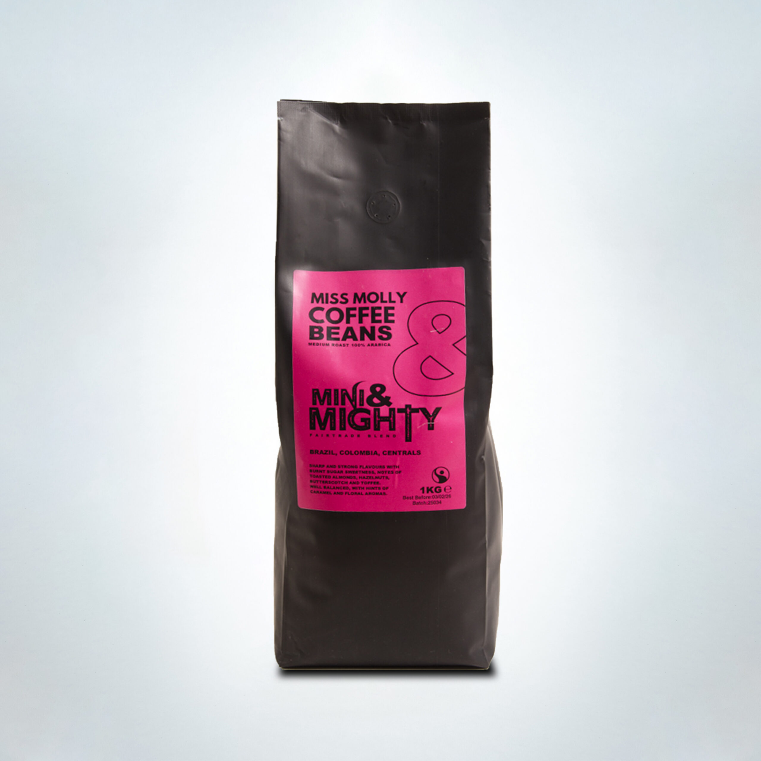 1kg bag of Mini & Mighty “Miss Molly” coffee beans with a bold pink Fairtrade label. A medium roast 100% Arabica blend from Brazil, Colombia, and Central America, delivering strong, sweet flavours with notes of burnt sugar, toasted nuts, butterscotch, and floral caramel aromas.