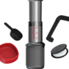 AeroPress Go travel coffee maker set including chamber, plunger, scoop, stirrer, filter holder, and travel cup — compact and portable brewing system for fresh coffee on the go.