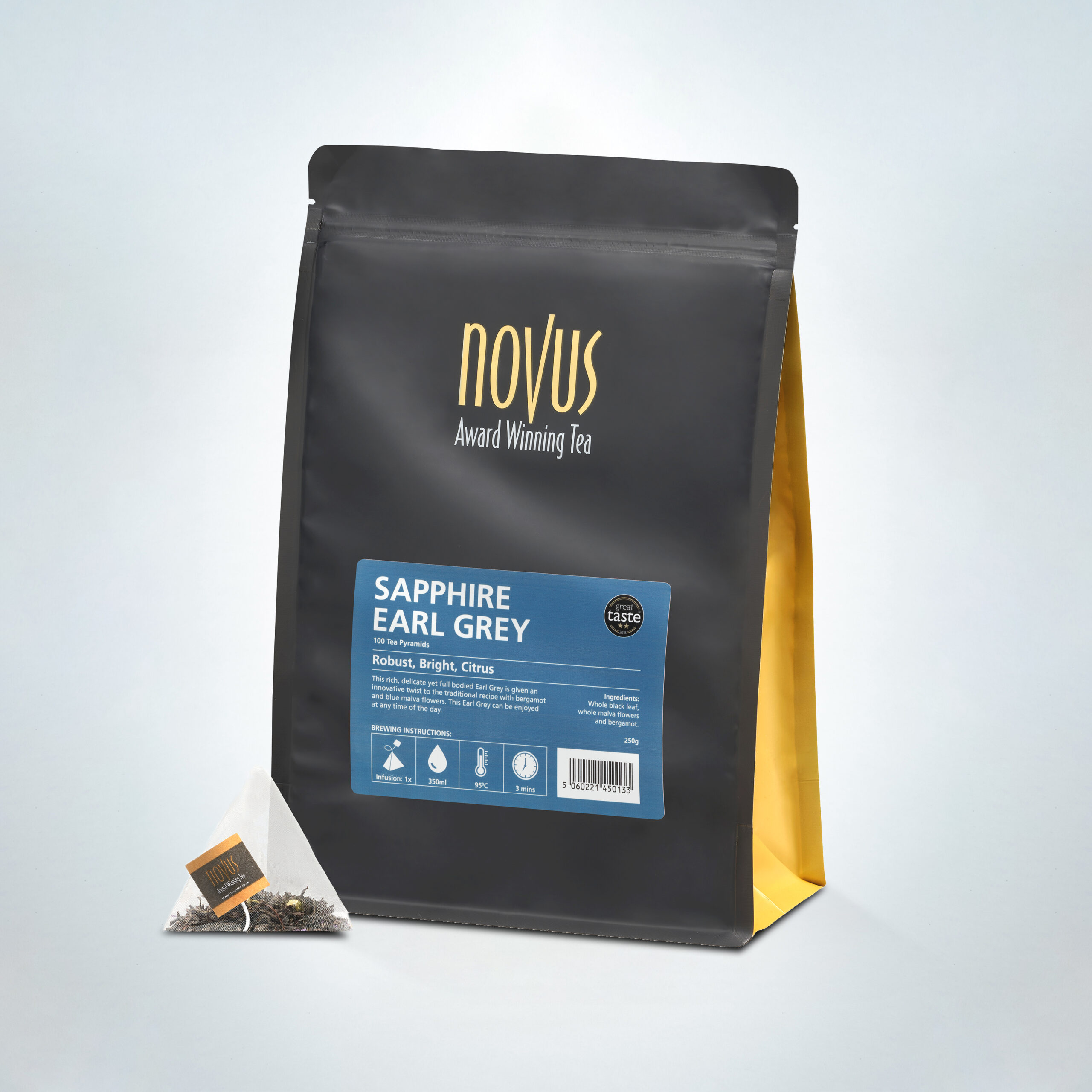 Novus Award Winning Sapphire Earl Grey Tea in a 100-pyramid bag pack, featuring bold, citrusy black tea with bergamot, shown in premium black and gold packaging with a single pyramid tea bag
