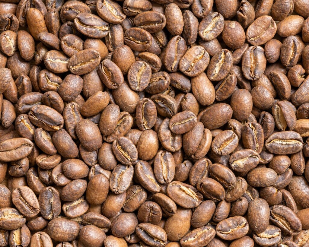 Close-up of light roast coffee beans, showcasing their rich brown color and smooth texture, perfect for brewing a flavorful, mild coffee