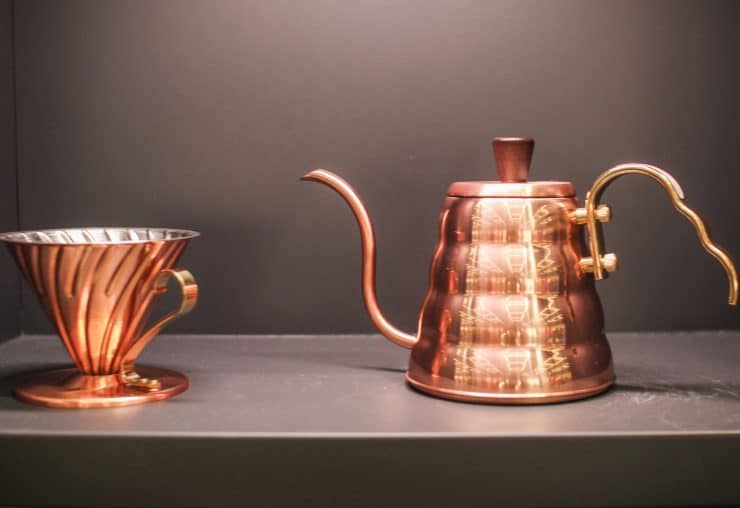 Brass Hario V60 coffee dripper and Buono kettle, designed for pour-over brewing, offering precision and control for high-quality coffee preparation
