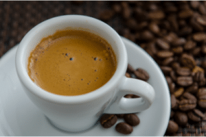 Close-up of a freshly brewed espresso shot with crema, showcasing high-quality coffee preparation using a professional espresso machine