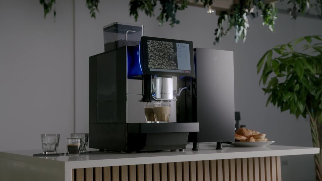 Bestir BM80 coffee machine preparing drinks on a modern countertop with touchscreen display — a high-capacity model from the Bestir coffee machines range.