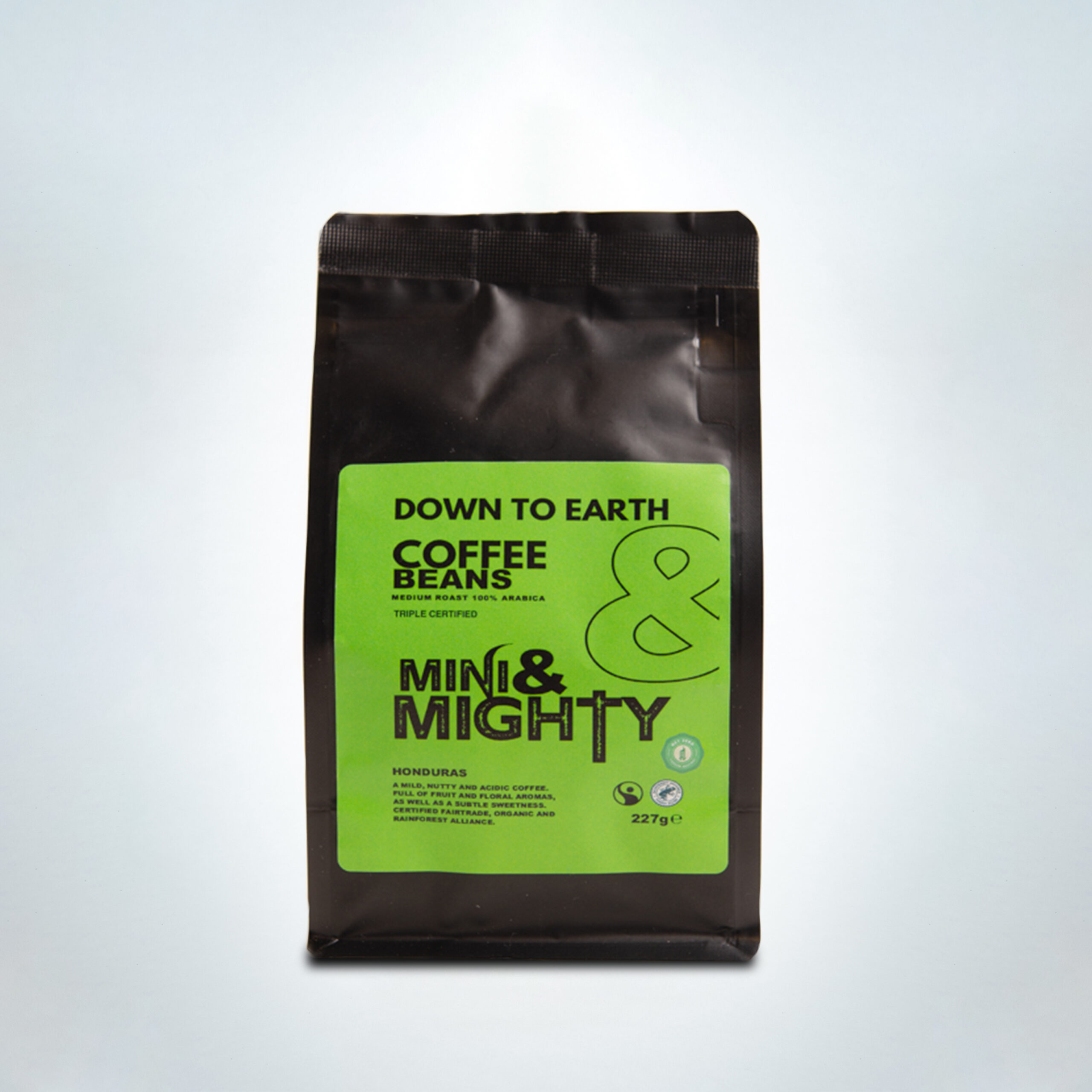 Mini & Mighty “Down to Earth” 227g whole bean coffee bag with eco-friendly bright green label. This triple-certified single origin Honduran coffee is medium roast 100% Arabica with nutty, floral, chocolate, and citrus notes. Ethically and sustainably sourced.