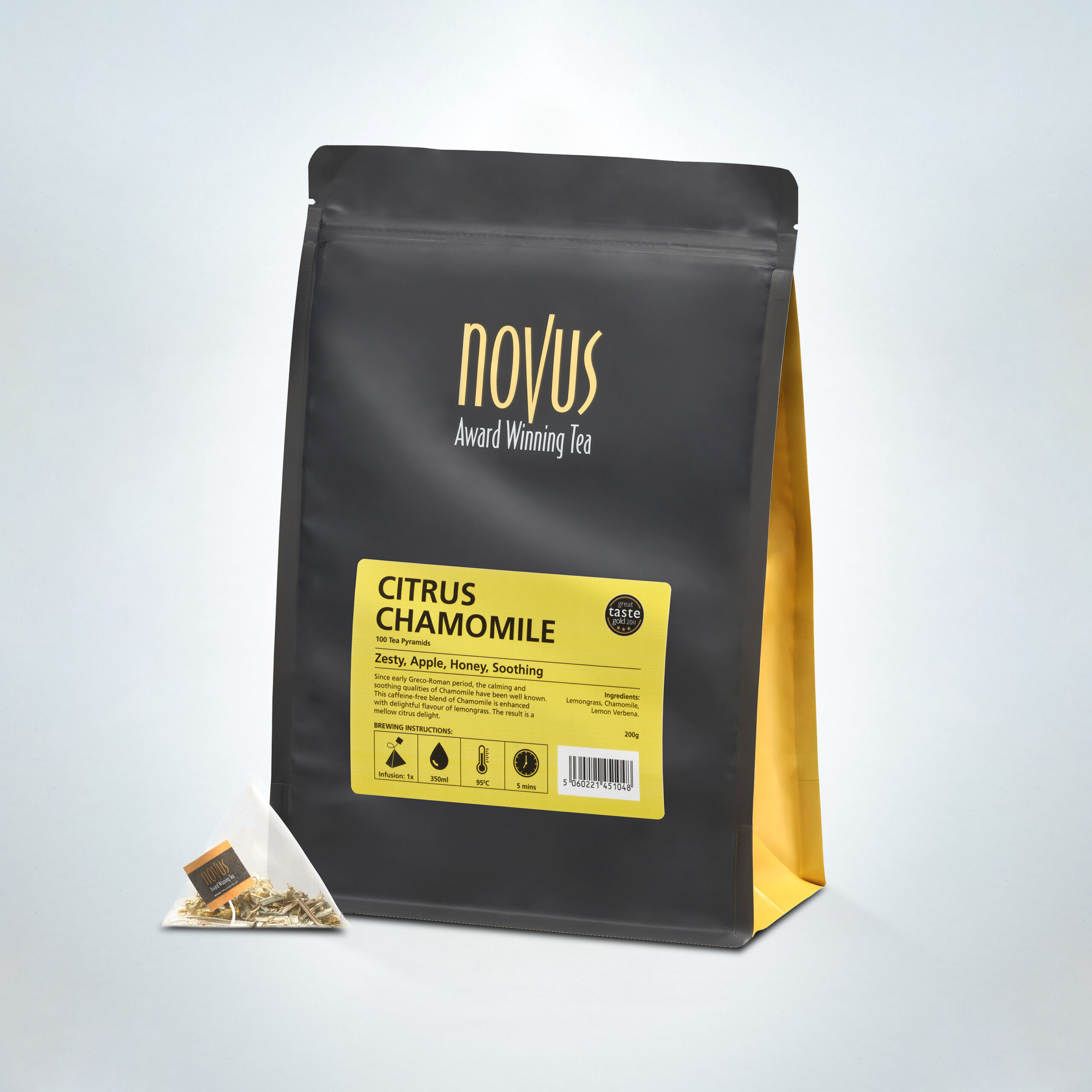 Novus Award Winning Citrus Chamomile Tea in a 100-pyramid bag pack, featuring zesty apple, honey, and soothing herbal notes, displayed with a pyramid tea bag and premium black and gold packaging