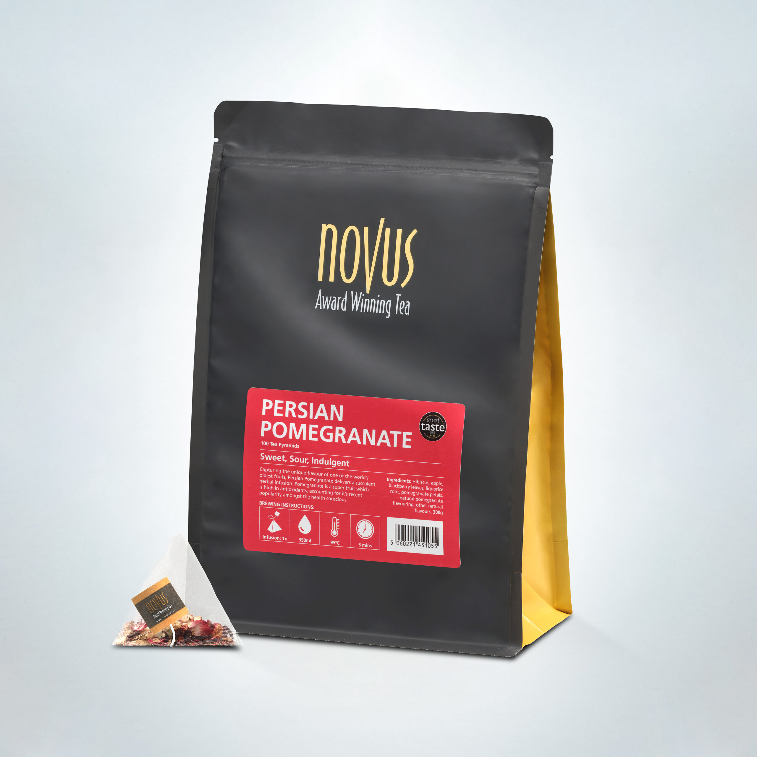 Novus Award Winning Persian Pomegranate Tea in a 100-pyramid bag pack, offering a sweet, sour, and indulgent fruity blend, displayed with pyramid tea bag and stylish black and gold packaging