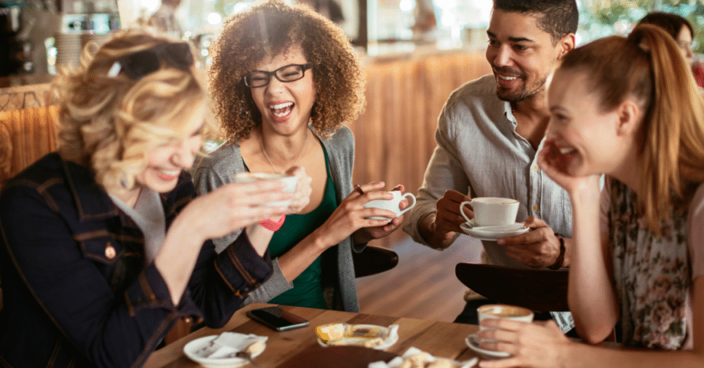 Group of friends enjoying coffee together in a café, highlighting the social side of the UK coffee market 2025 and the continued café culture boom.